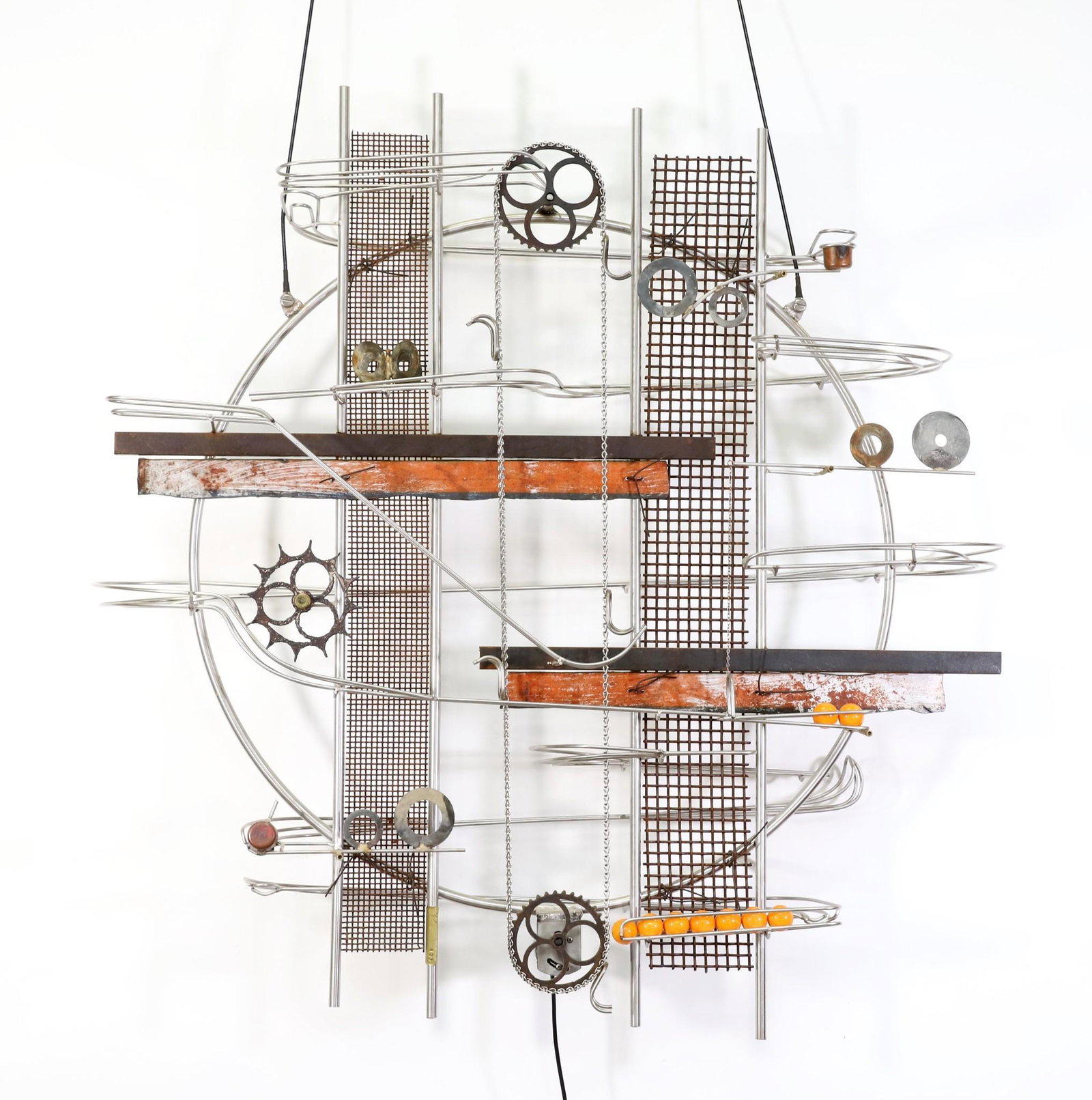 Jeffrey Zachmann Kinetic Sculpture: No. 853 Electric Kinetic Sculpture, made from found metal, wall mounted with brackets, numbered brass plate lower center, including (10) glass balls, and pen signed instructions. Currently functions. 