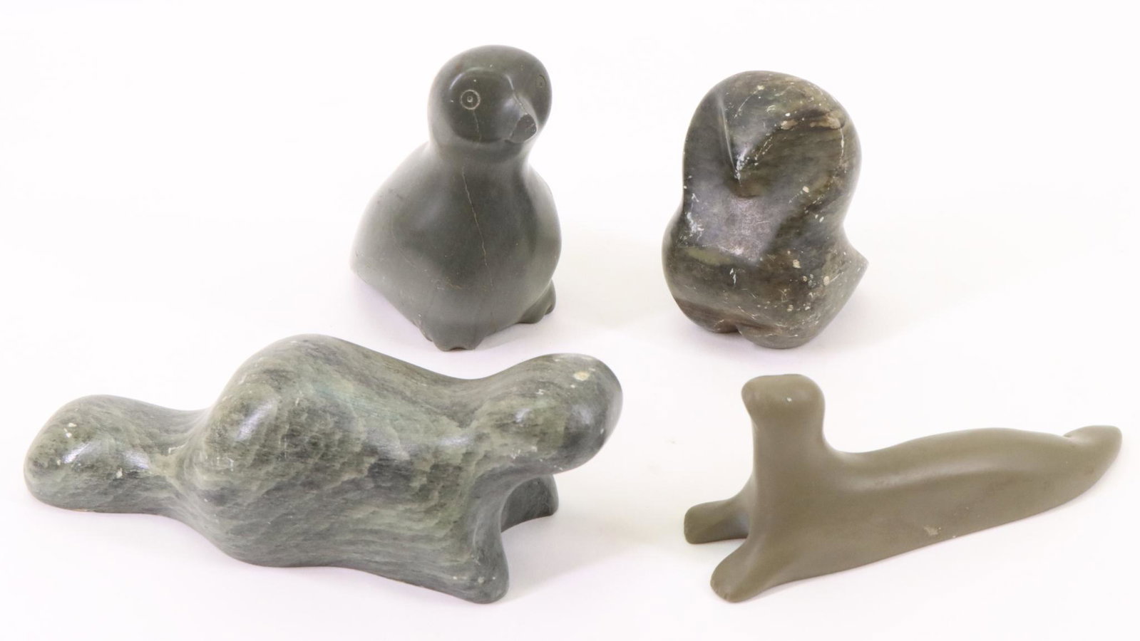 Inuit Carvings: Inuit carving of a standing bird and stylized sitting bird, both signed. Beaver and seal also signed. Largest measures 2”h x 6”w