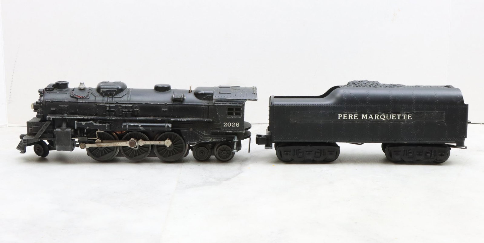 Lionel Trains 2026 Locomotive and Pere Marquette Tender: Postwar, O27 gauge, 2-6-4 locomotive 2026, and unmarked Pere Marquette tender. The nameplate on the tender has been altered.