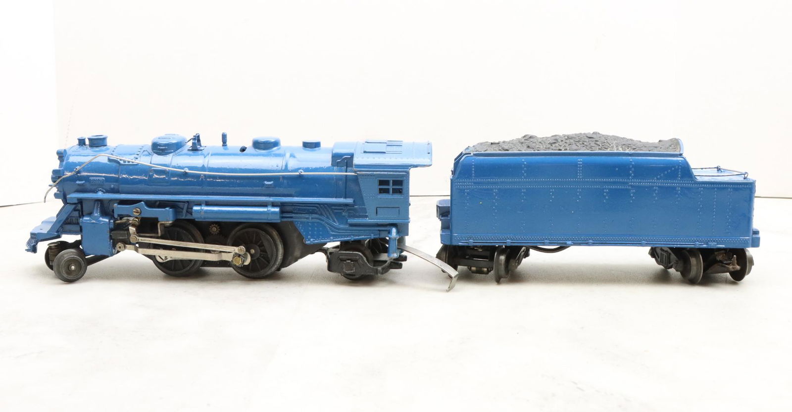 Lionel Trains 1664E Locomotive and 2466T Tender: Prewar, O27 gauge, 2-4-2 locomotive 1664E, and postwar tender 2466T. Both have been painted blue.
