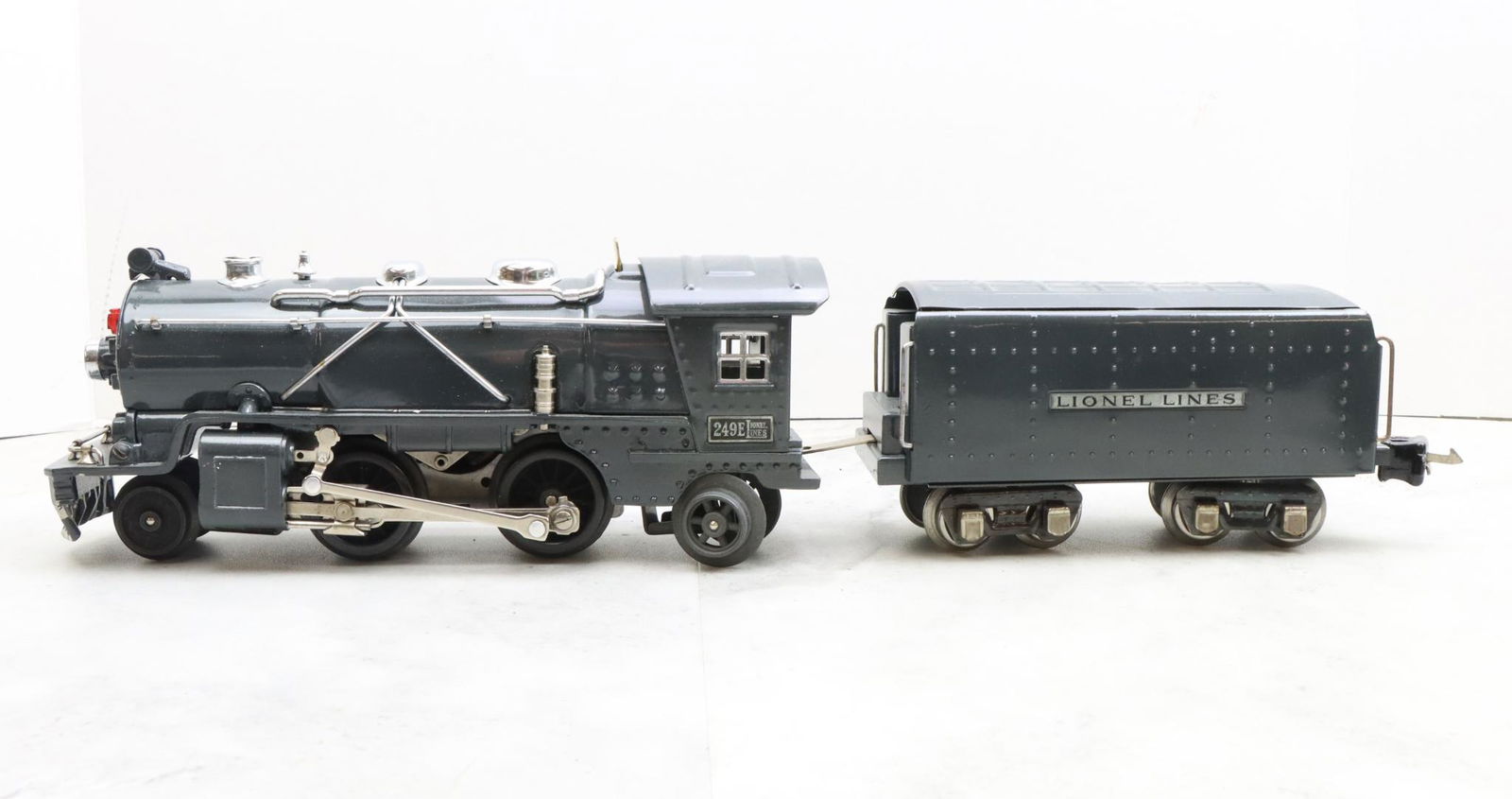 Lionel Trains 249E Locomotive and Tender: Prewar, O gauge, 2-4-2 gunmetal gray locomotive 249E, and gunmetal gray unmarked tender.