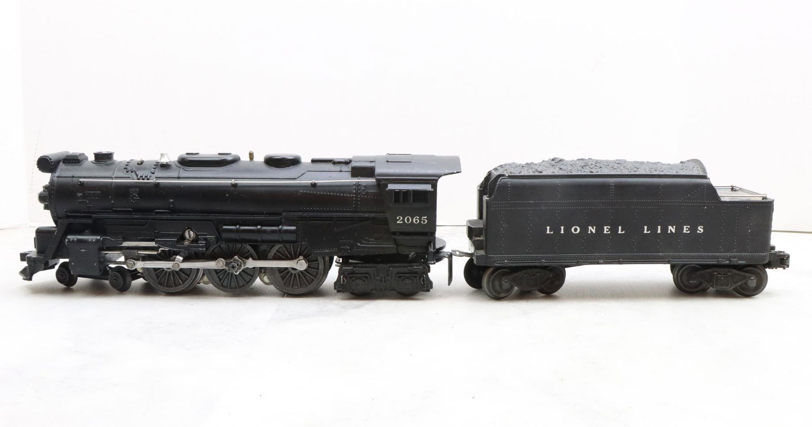 Lionel Trains 2065 Locomotive and 2466WX Tender: Postwar, O27 gauge, 4-6-4 locomotive 2065, and O gauge tender 2466WX.