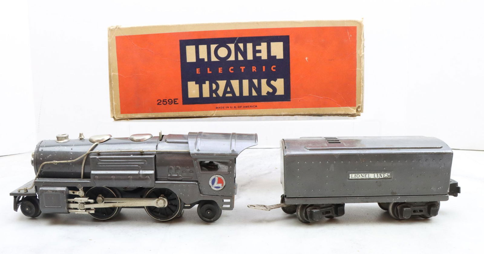 Lionel Trains 259E Locomotive and Tender: Prewar, O gauge, 2-4-2 gunmetal gray locomotive 259E with original box, and gunmetal gray unmarked tender.