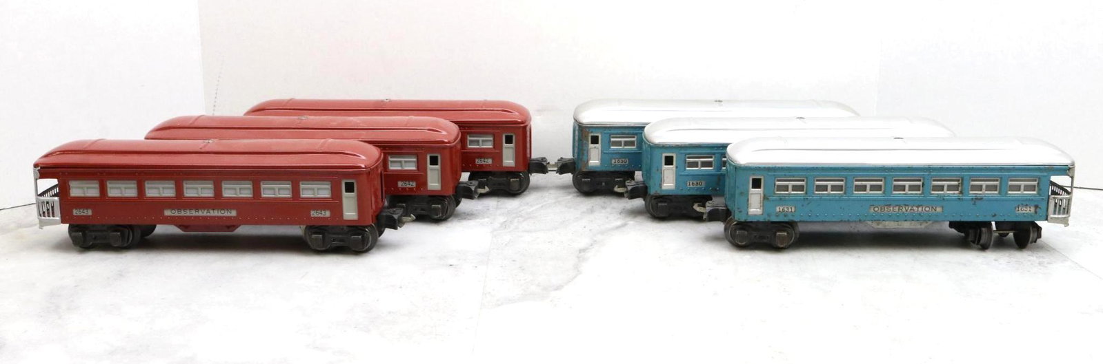 Lionel Trains Prewar Passenger Cars: Prewar, O gauge, red Pullman 2642 (2) and Observation 2643 cars, and blue Pullman 1630 (2) and Observation 1631 cars.