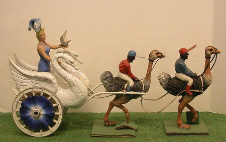 Model Circus Lot.: Model Circus Lot. Swan cart being pulled by team of 2 ostrich with Black jockeys, 16" overall. Condition: see Auction Terms and Conditions below.