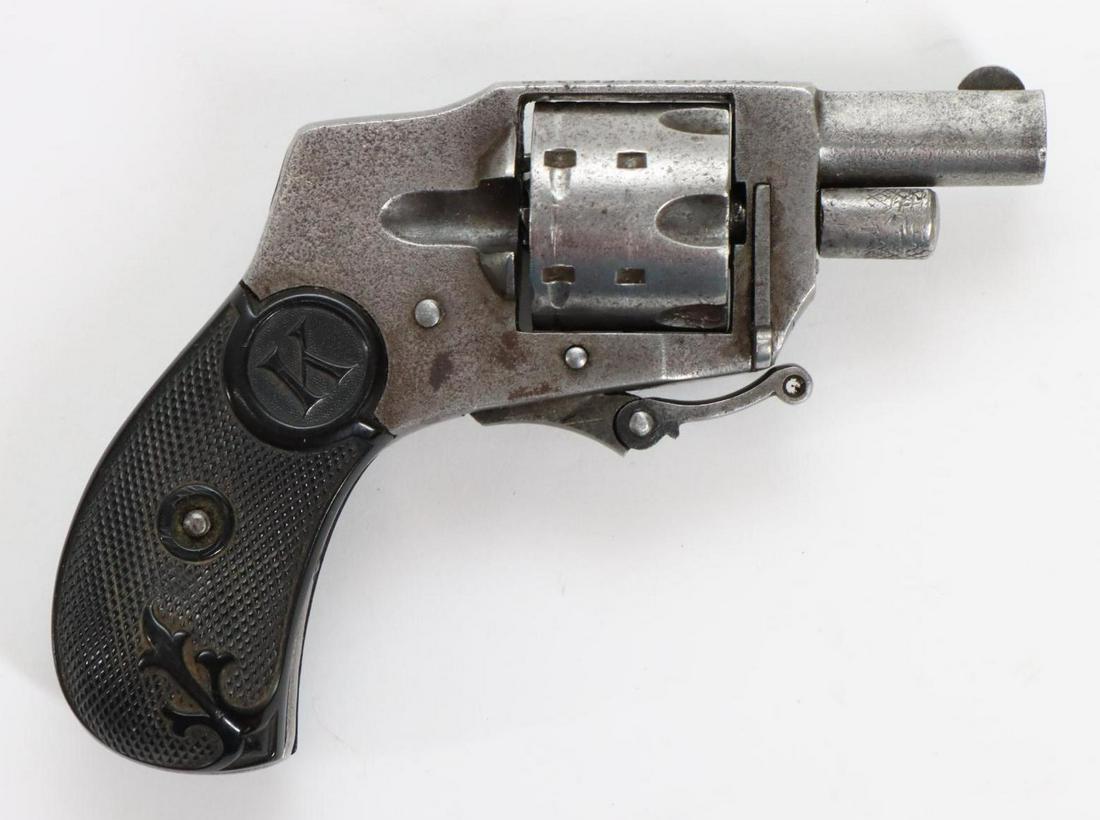 Kolb Baby Hammerless Double Action Revolver: 22 short, 1 1/4" bbl, NSN. Silver/gray patina, fair bore, folding trigger, checkered grips show light handling. Good condition. 22-902 C&R