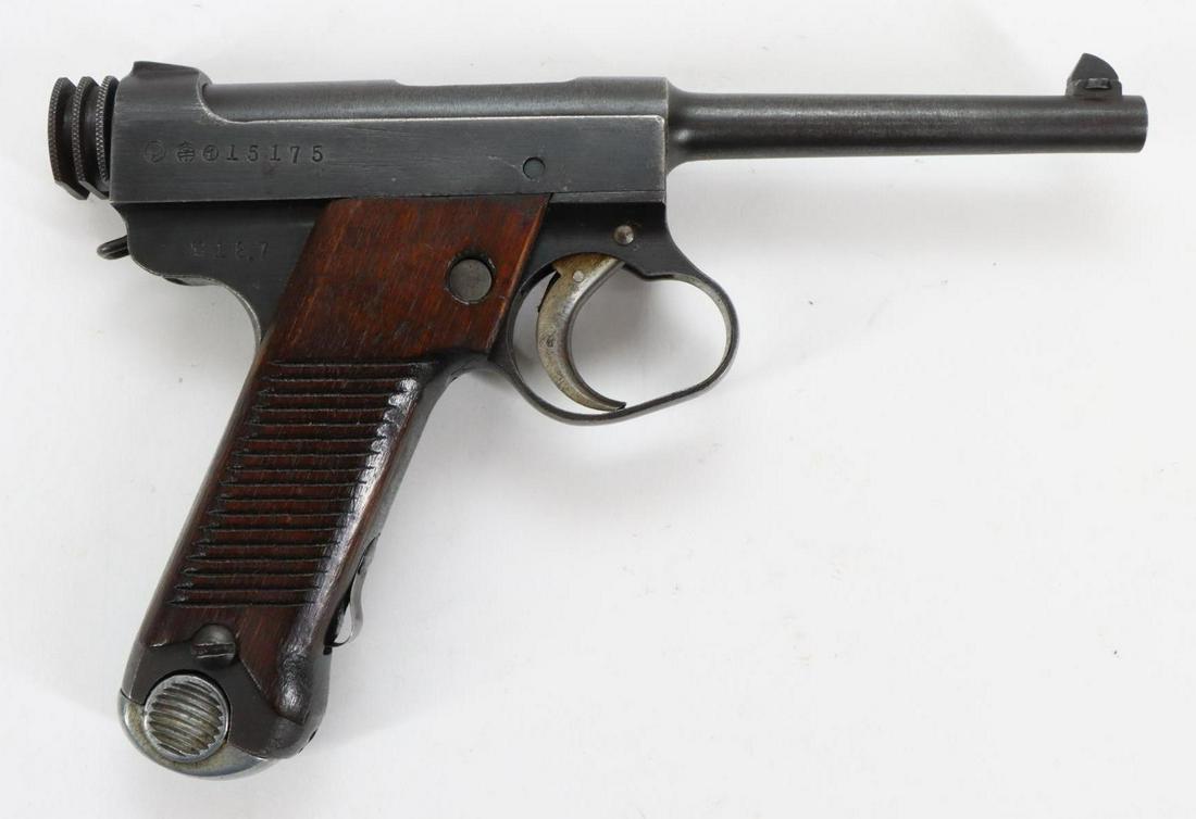 Kokubunji/Nagoya Type 14 Nambu First Series Semi Automatic Pistol: 8mm Nambu, 4 1/2" bbl, SN 15175. Gray/silver patina, good bore, large trigger guard, ribbed wood grips show average handling,1-8 rnd magazine. wood wall display with spaces to display pistol and 5 rnd