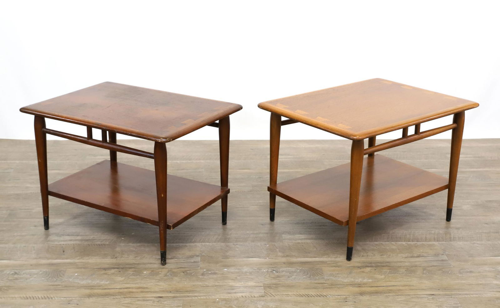 Andre Bus for Lane "Acclaim" End Tables: Pair of two-tier end tables, walnut with exposed dovetailing and tapered round legs. 20"h x 28"w x 21"d **Please Note: This item is NOT eligible for in-house shipping. Please refer to the terms and co