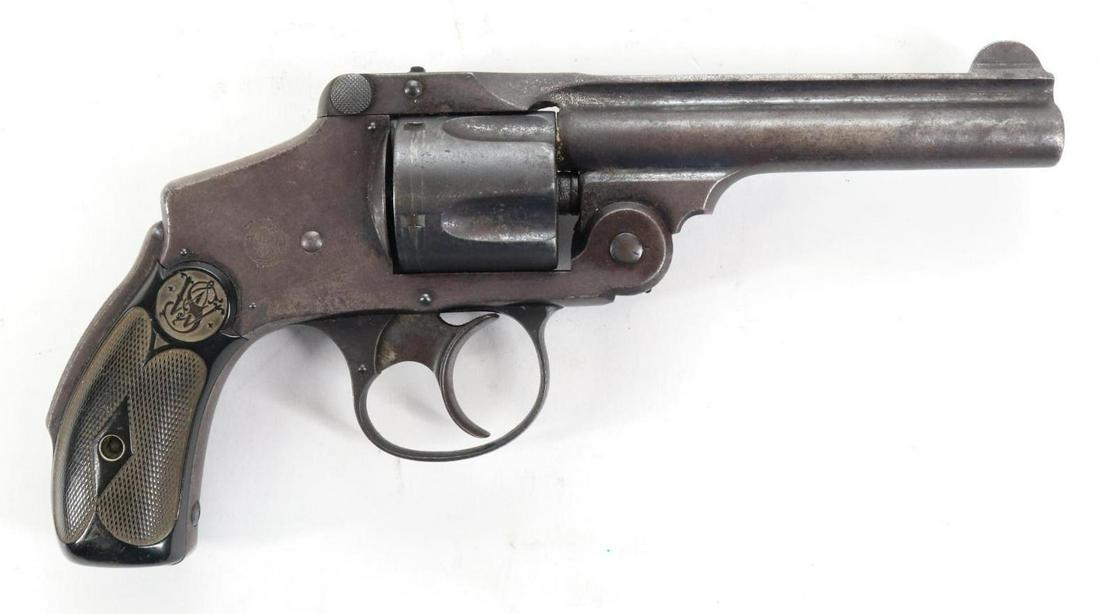 Smith & Wesson Safety Hammerless (Lemon Squeezer) Double Action Revolver: 38 S&W, 4" bbl, SN 218614. Gray/brown patina, fair bore with areas of pitting, checkered plastic diamond pattern grips show average handling. Good condition. 22-1316 C&R