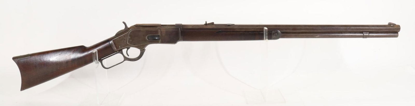 Antique Winchester 1873 Lever Action Rifle: 44WCF, 24 1/4" octagon bbl, SN 224154B. Dark brown mottled patina, fair bore, light oxidation around bolt and elevator, side pinch dust cover, wood stock and highly figured forearm show average handli