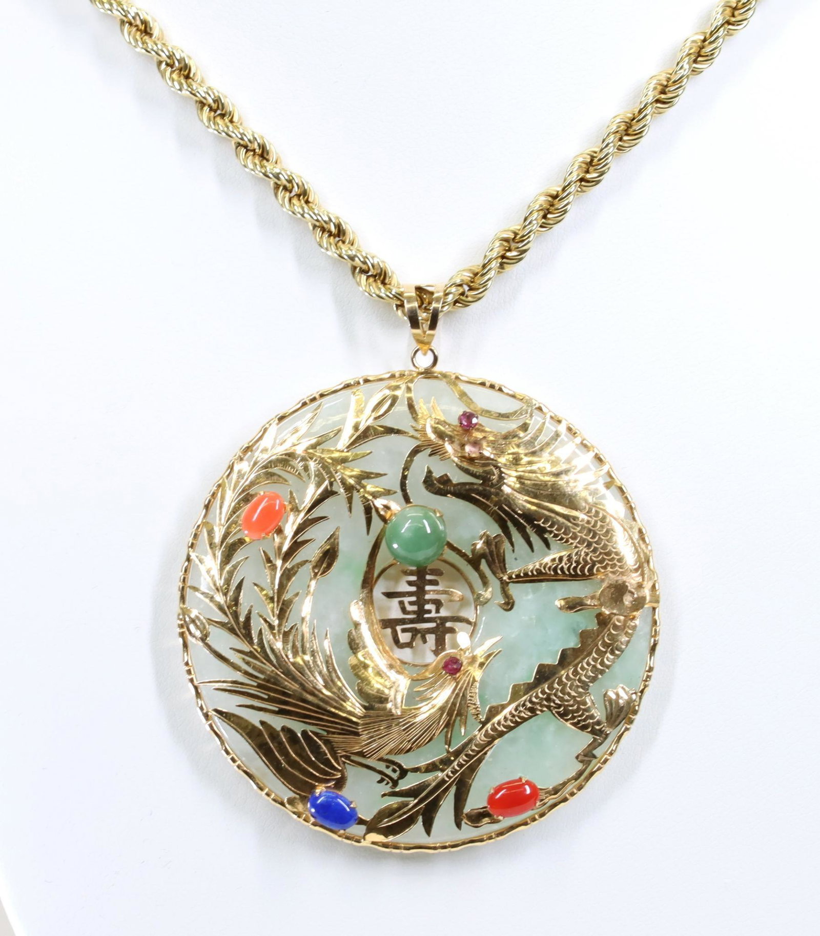 14KY Gold Jade Bi Disc Pendant on Chain: Jade bi disc with 14ky gold features a decorative gold overlay on front depicting a dragon and a bird accented by cabochons of coral, jade, lapis, and carnelian(?), and (2) small round faceted rubies.