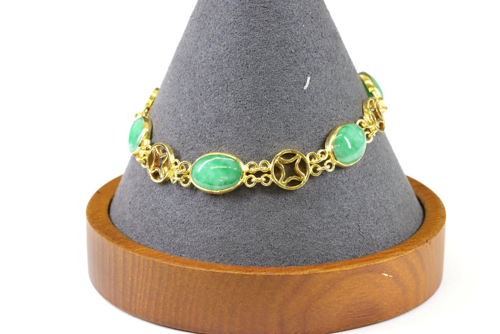 18KY Gold Jadeite Bracelet: Link bracelet in 18ky gold features oval jadeite cabochons, alternating with a circular link and chain, (5). 10mm wide, 7.25" long with hook and ring clasp. 17.0gtw