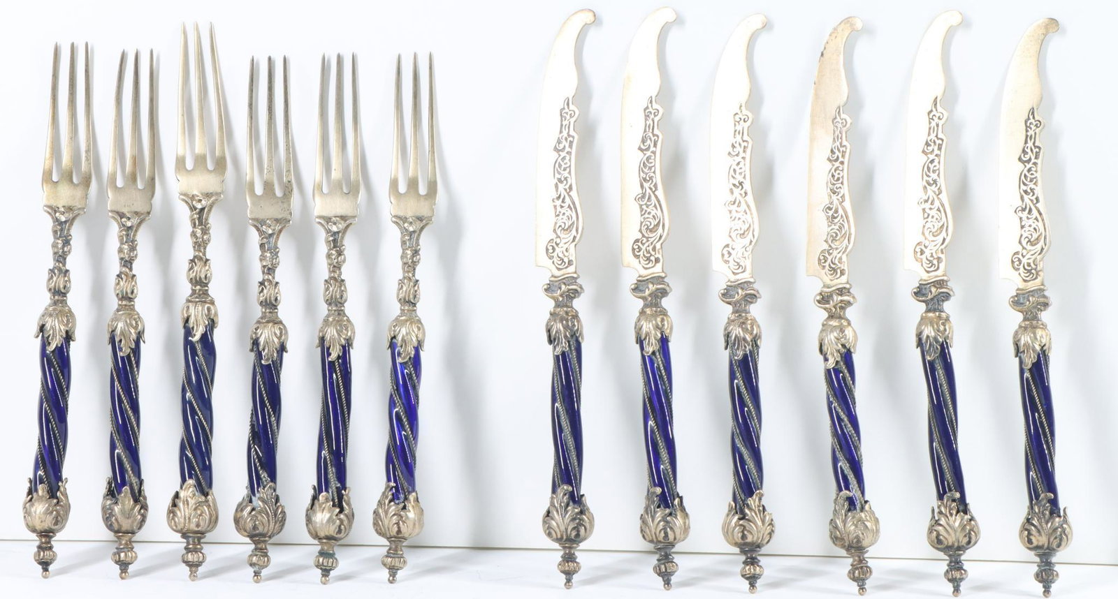 Ludwig Politzer 900 Silver and Enamel Dessert Set: Austria-Hungary, gold wash 900 silver dessert set for 6 with forks and knives, with floral and foliate decoration, crown form terminals, and cobalt enamel twist handles. Forks 5.75", knives 6"