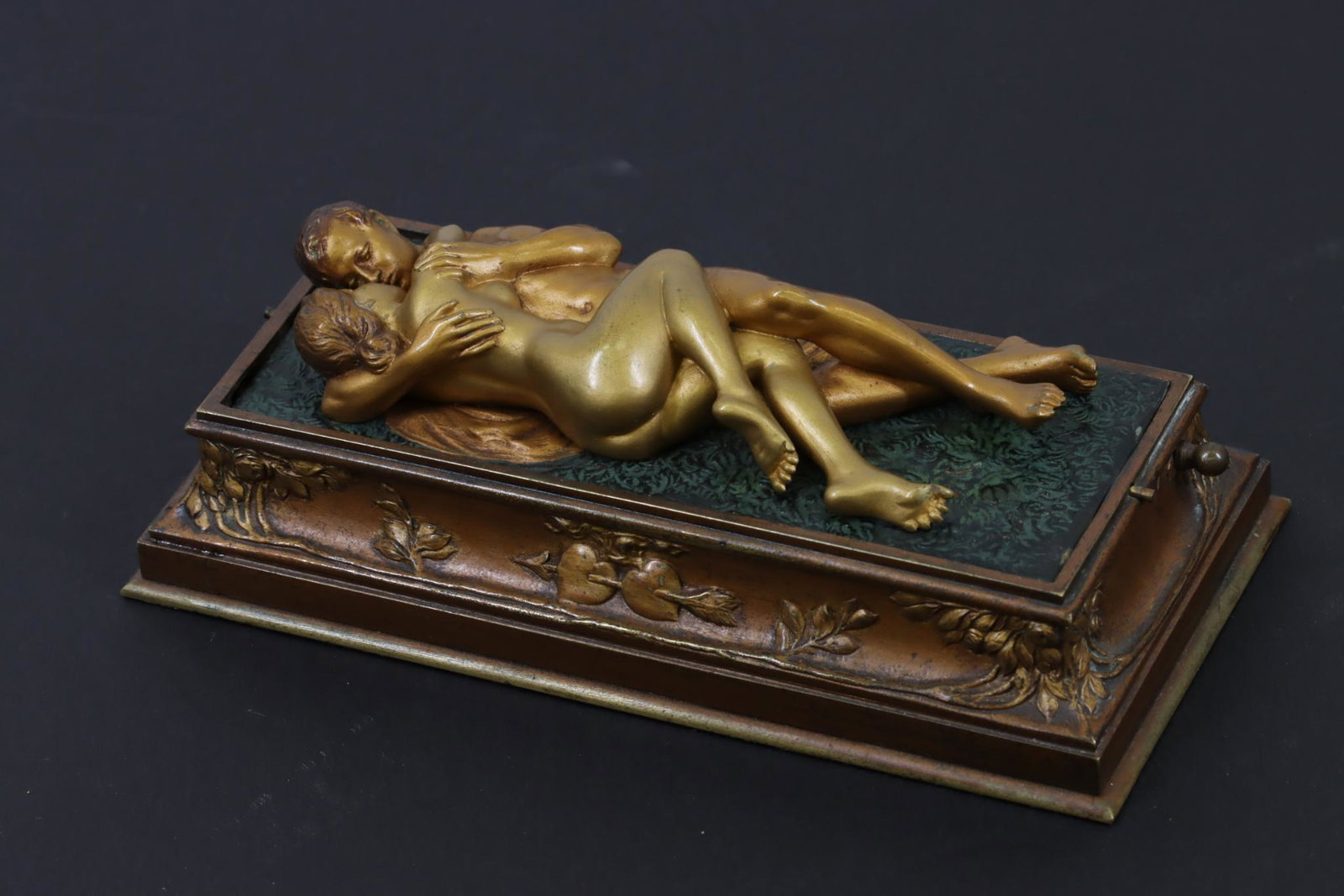 Franz Bergman Cold Painted Bronze Erotic Model: Early 20th century cold painted bronze designed as a rotating platform with one side being three resting sheep and the other an amorous couple. Plinth decorated with a pair of pierced hearts and folia