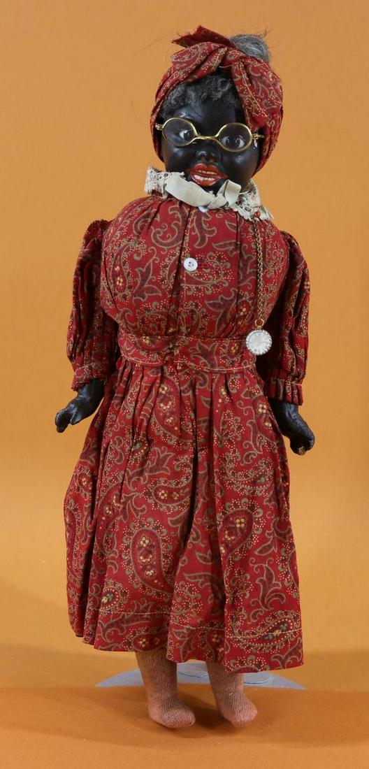 BLACK DOLL(S).: 15 1/2" Character Lady doll with papier mache shoulder head, stationary brown eyes, gray mohair wig, open/closed mouth. Cloth torso with papier mache arms/legs. Dressed in antique cotton print dress w