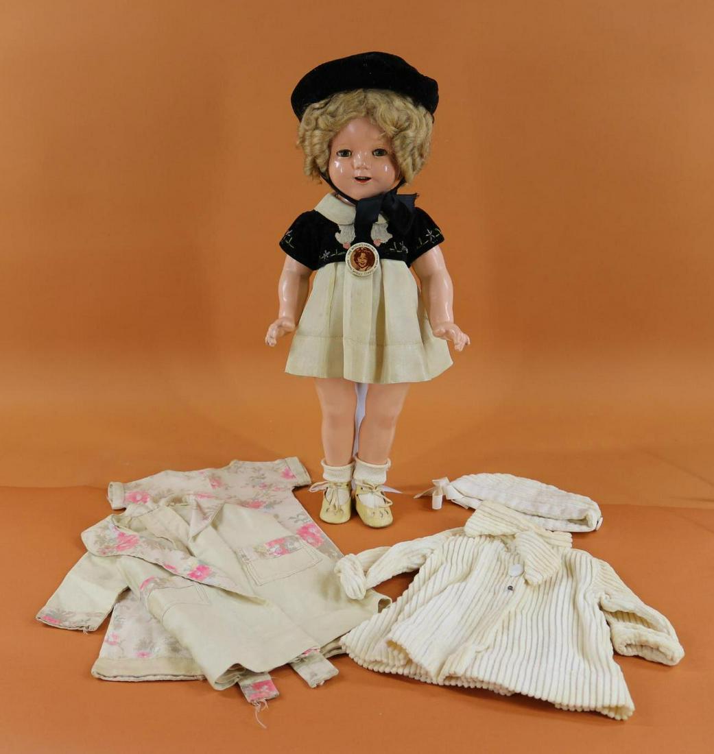SHIRLEY TEMPLE.: LOT. 18" Ideal composition doll with original wig. Dressed in unmarked 3 pc. outfit - Ivory taffeta dress with black velveteen over blouse and matching hat; oilcloth shoes. Comes with unmarked clothin