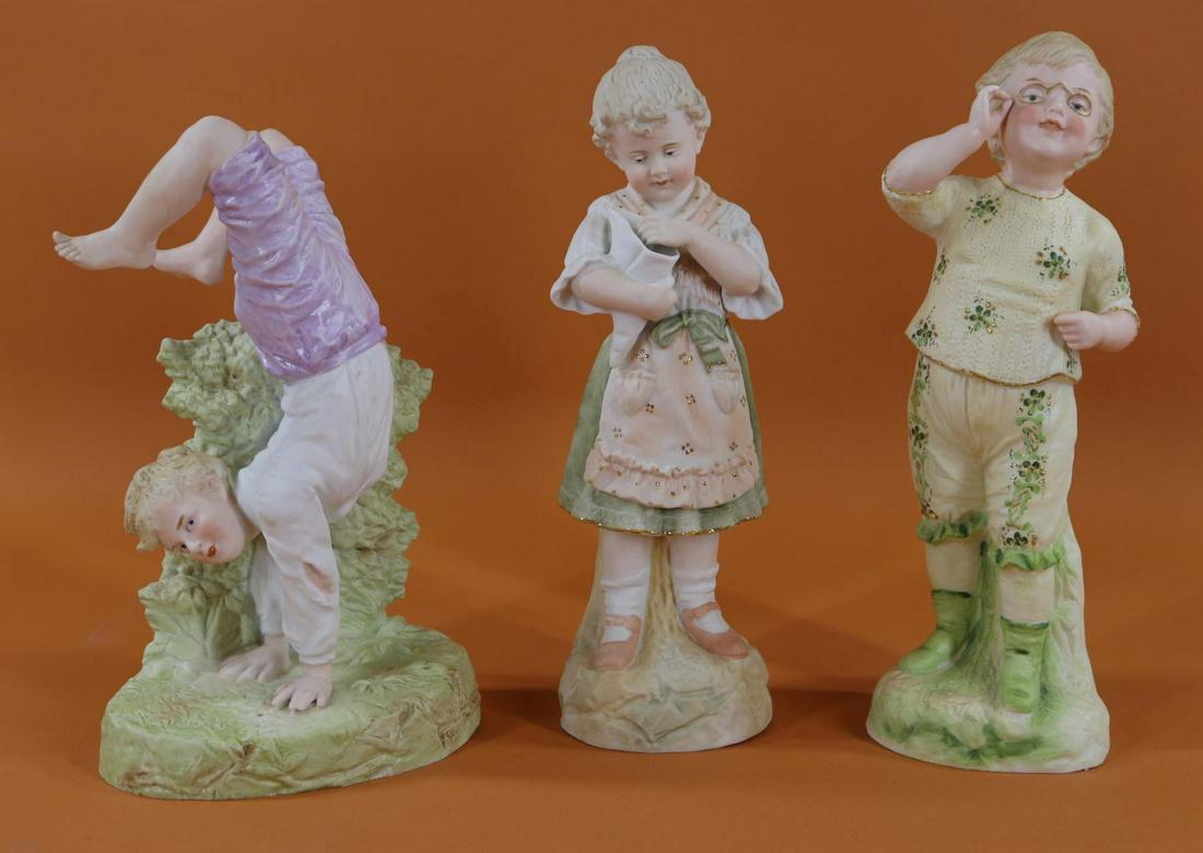 BISQUE FIGURINES.: Lot of (3) children marked Made in Germany. All of them have intaglio eyes. 11 1/4" Girl holding large shell. Condition: 1" crack on inside near mark. 10" Boy marked on back ED. COPYRIGHT. He is stand