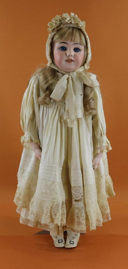 GERMAN BISQUE HEAD DOLL.: 28" S & H 1009 DEP Doll. Socket head doll on a bisque shoulder plate. Blue sleep eyes, open mouth, pierced ears, honey blonde French human hair wig. Antique cloth torso with leather gusseted legs; lea