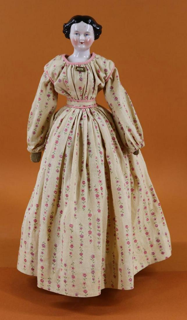 CHINA HEAD DOLL(S).: 16" Antique doll with black center part hair, sides swept back into a braided bun, molded bow. (Similar to the Jenny Lind style.) Blue eyes. All cloth body appears to be original. Mitt hands. Dressed 