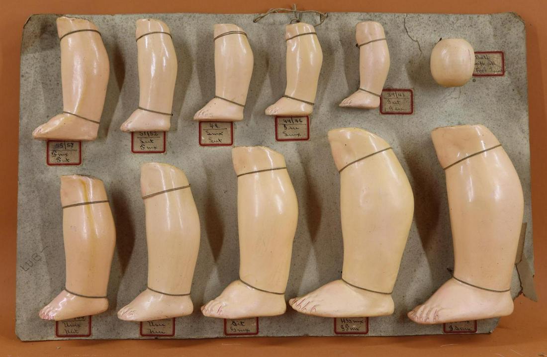 SALESMAN'S SAMPLE CARD - GERMAN BODY PARTS.: Lot of German papier mache parts from a 1930's Philadelphia doll hospital - (10) LOWER left LEG sections. (1) Has the separate ball joint with it. 4" - 8". Condition: this lot is being sold AS IS.