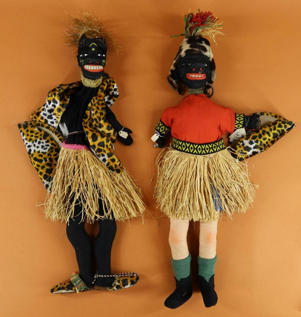 WOODEN DOLLS/PUPPETS/MARIONETTES.: Pair of black ELSE HECHT, HECHPUPPE full body puppets. Only (1) is tagged. Both are dressed in grass skirts, and have their "leopard" satchels with them. Condition: age loss/discoloration on clothing.