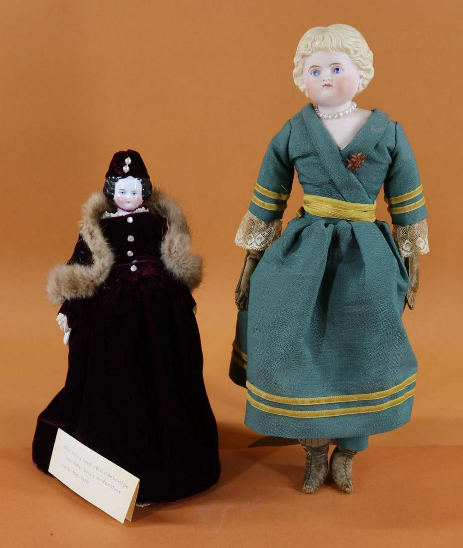 GERMAN BISQUE HEAD DOLL/OTHER.: Pair of dolls. German bisque shoulder head doll - 15" "4" doll with molded blonde hair, painted features inc. blue eyes, closed mouth. Cloth body with brown leather arms, sewn down fingers. Blue leath