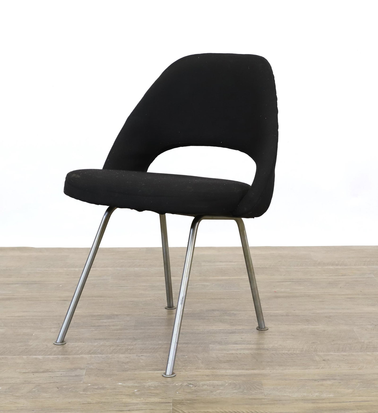 Eero Saarinen for Knoll Executive Chair: Side chair with tubular chrome legs, molded plywood back and seat with padded black upholstery, labeled. Stains and soiling. 31"h x 22"w x 20"d, seat height 18" **Please Note: This item is NOT eligibl