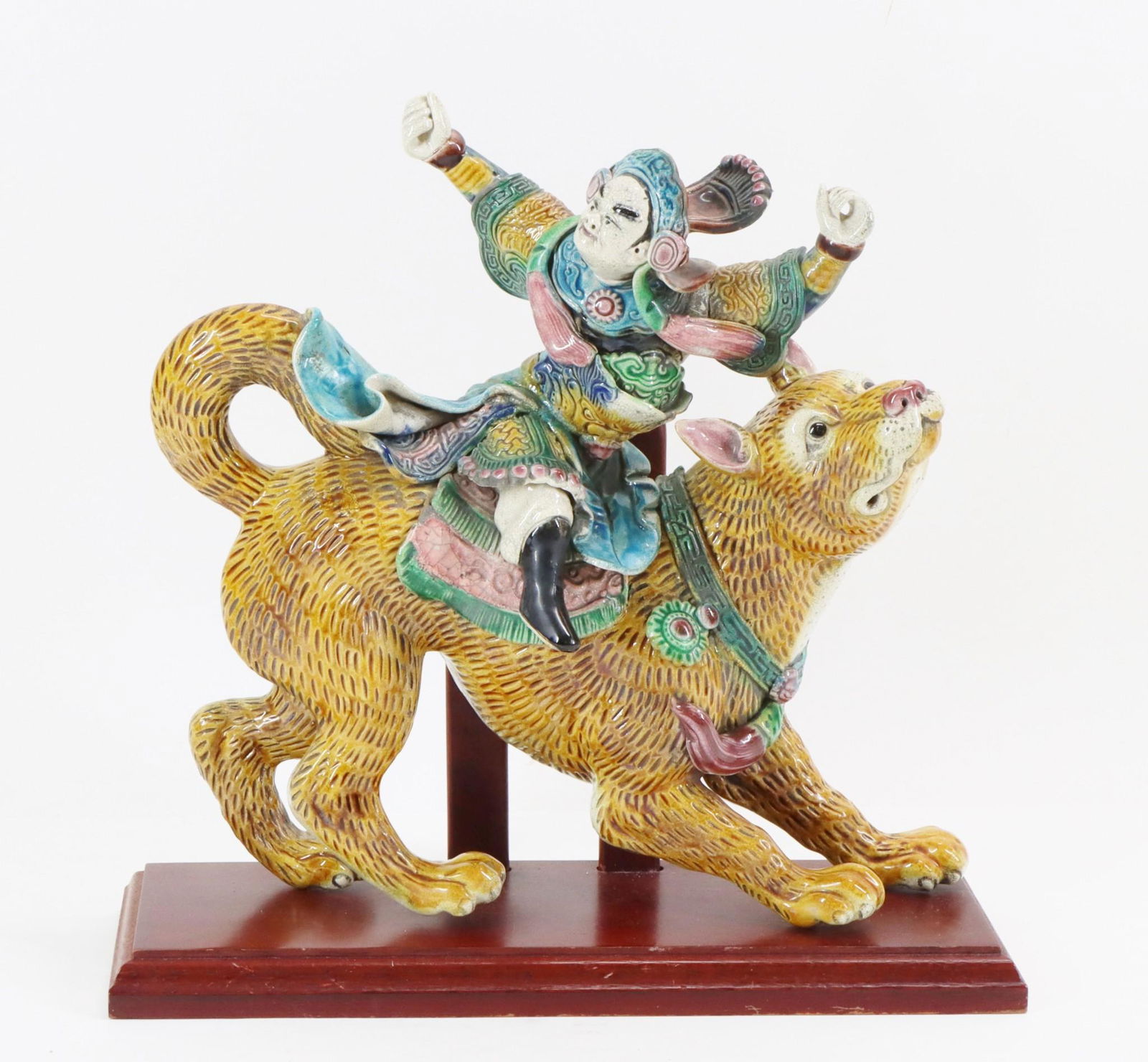 Tibetan Pottery Roof Tile: Sancai glazed ceramic roof tile in the form of a Protector of Buddhism riding astride a mythical wolf. Impressed mark. 12"h x 12"w x 4"d; 13"h x 13"w x 5"d with stand **Please Note: This item is NOT e