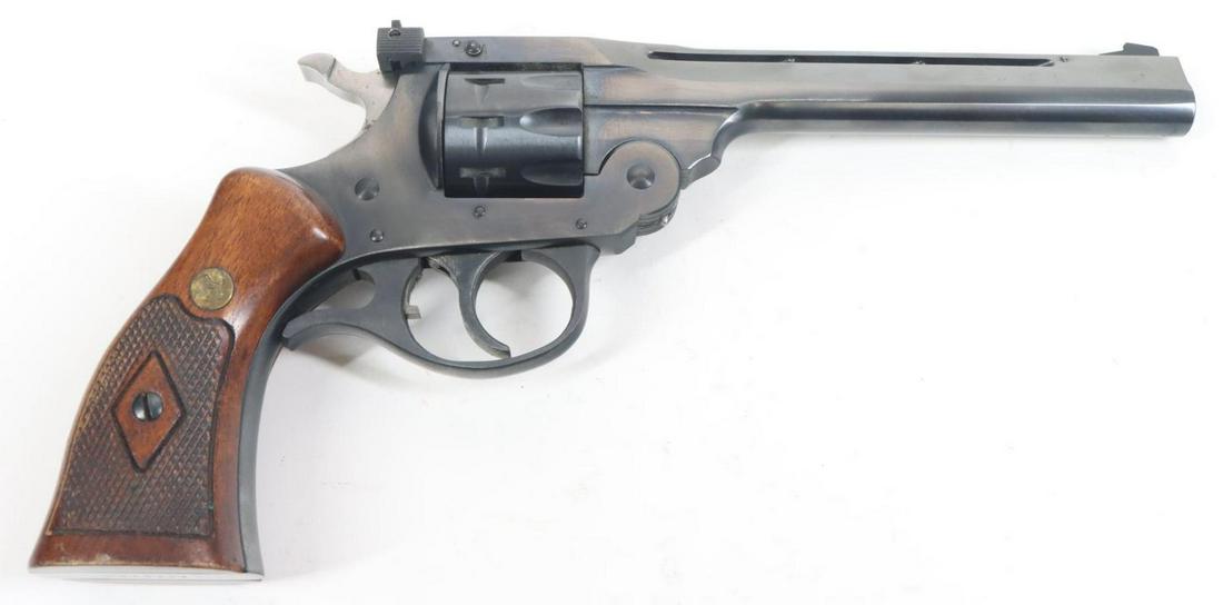 H&R Inc Sportsman Model 999 Double Action Revolver: .22, 6" bbl, SN AD75156. 99% blue finish shows light handling, good bore, adjustable sights, vent rib, checkered wood grips with H&R medallions on both sides show average handling. Good condition. 22-