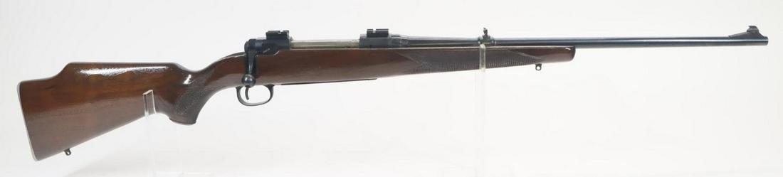 Vintage Savage Model 110 Bolt Action Rifle: 30-06, 22" bbl, SN 48505. 98% blue finish show light average handling, very good bore, fold down rear sight, Weaver style scope mounts, older refinished checkered wood stock shows average handling. 13