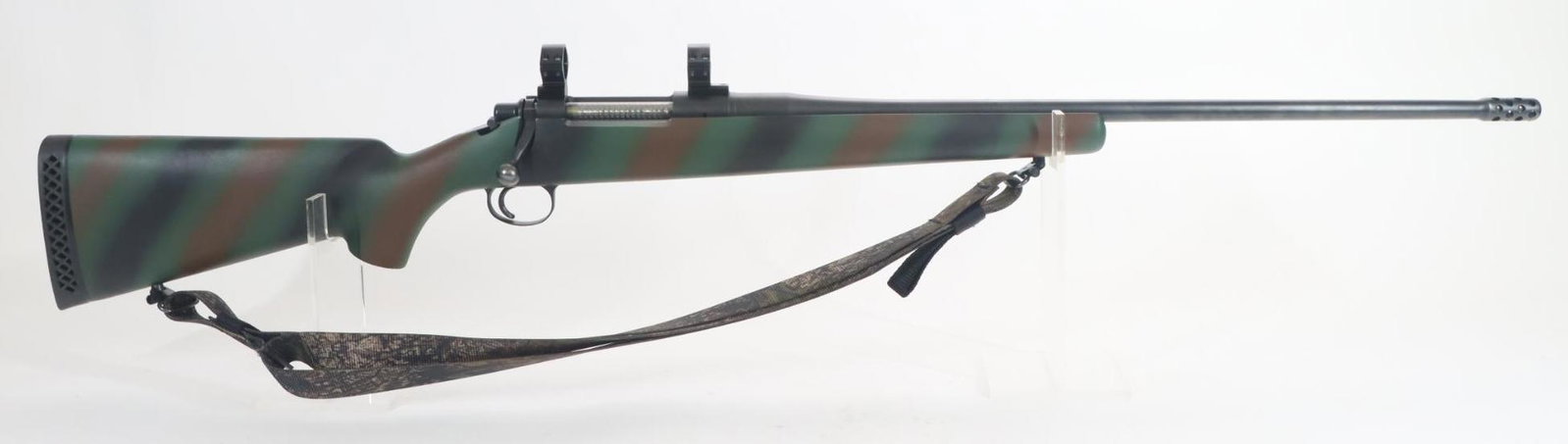 Ultra Light Arms Model 28 Bolt Action Rifle: 300 Win Mag, 25 1/2" bbl with integral muzzle brake, SN 87-127. 98% blue finish shows average handling with a few small scratches near muzzle, good bore, jeweled bolt, Weaver style scope rings and mou