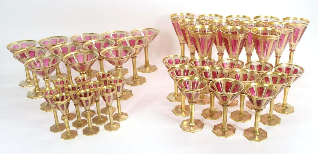 Bohemian Amethyst-Tinted and Gilt-Glass Stemware: Bohemian amethyst-tinted and gilt-glass wine glasses with raised amethyst panels against a gilt foliate ground. Largest 9”h **Please Note: This item is NOT eligible for in-house shipping. Please