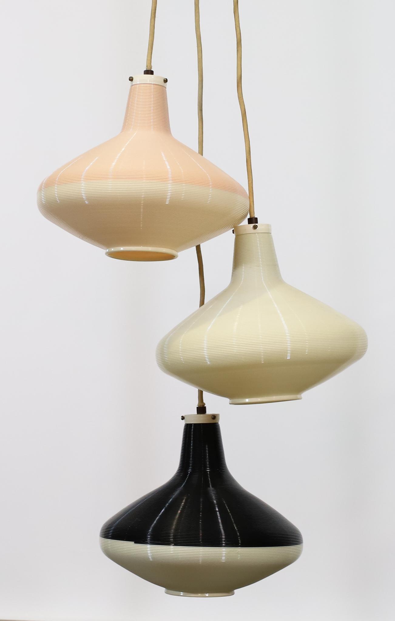 Yasha Heifetz for Rotaflex Pendant Lights: Spun cellulose acetate hanging teardrop pendant lights (3), in black, white, and pink, arranged as a single fixture, unmarked. The electrical wiring has been cut at ceiling length; not tested. Each pe