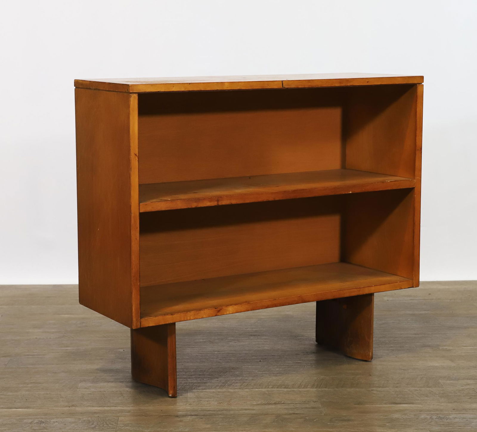 Eliel Saarinen for John Stuart S Series Bookshelf: Birchwood 2-tier bookshelf with S-scroll legs, labeled for John Stuart. Surface wear. 30.5"h x 34"w x 12"d **Please Note: This item is NOT eligible for in-house shipping. Please refer to the terms and