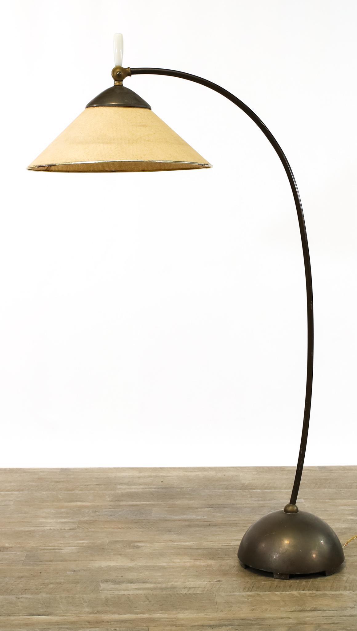 Russel Wright Pivoting Floor Lamp: Patinated brass and steel, adjustable shade with bakelite handle. Unable to be tested, needs rewiring. 52"h **Please Note: This item is NOT eligible for in-house shipping. Please refer to the terms an