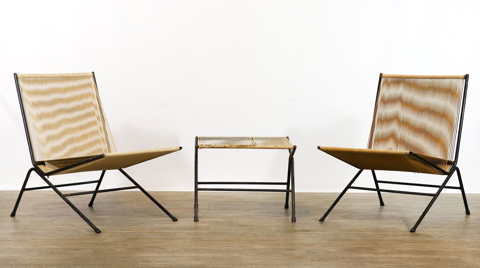Allan Gould String Chairs and Ottoman: Lounge chairs (2), and a stool, cord wrapped iron frames. Some frays to the cord on the stool; stains. 28.5"h x 20"w x 28"d, seat height of 15". Ottoman 15"h x 20"w x 18"d **Please Note: This item is