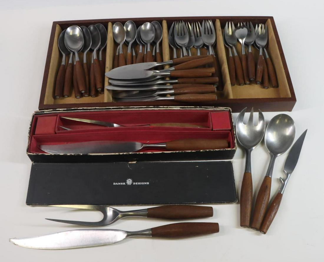 Teak Handle Dansk Flatware & Serving Pieces: Teak handle Dansk flatware set for 8. Includes 7" dinner forks, lunch forks, place spoons, soup spoons, and 8.25" knives. Also includes 7 serving pieces. Carving knife 14". Tray 20"w x 9.5"d.