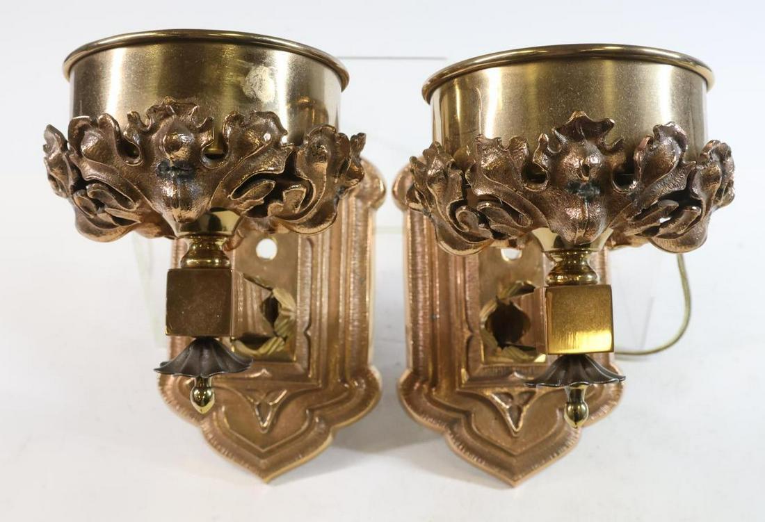Arts and Crafts Style Sconces: Bronze and brass, pair of torch sconces with foliate decoration. The electrical wiring has been cut; untested. 9”h x 5”w x 10”h