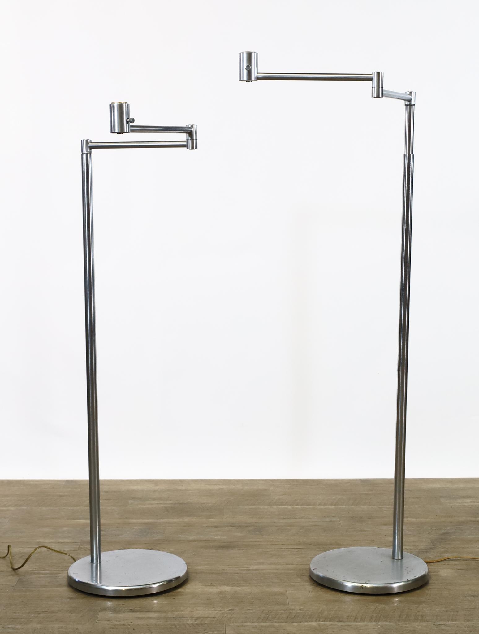 Walter Von Nessen Floor Lamps: Aluminum swing arm adjustable floor lamps, pair, marked. Missing the shades. One is in working condition, the other is untested and needs rewiring. Adjusts from 43"h to 54"h; maximum arm length 23" **