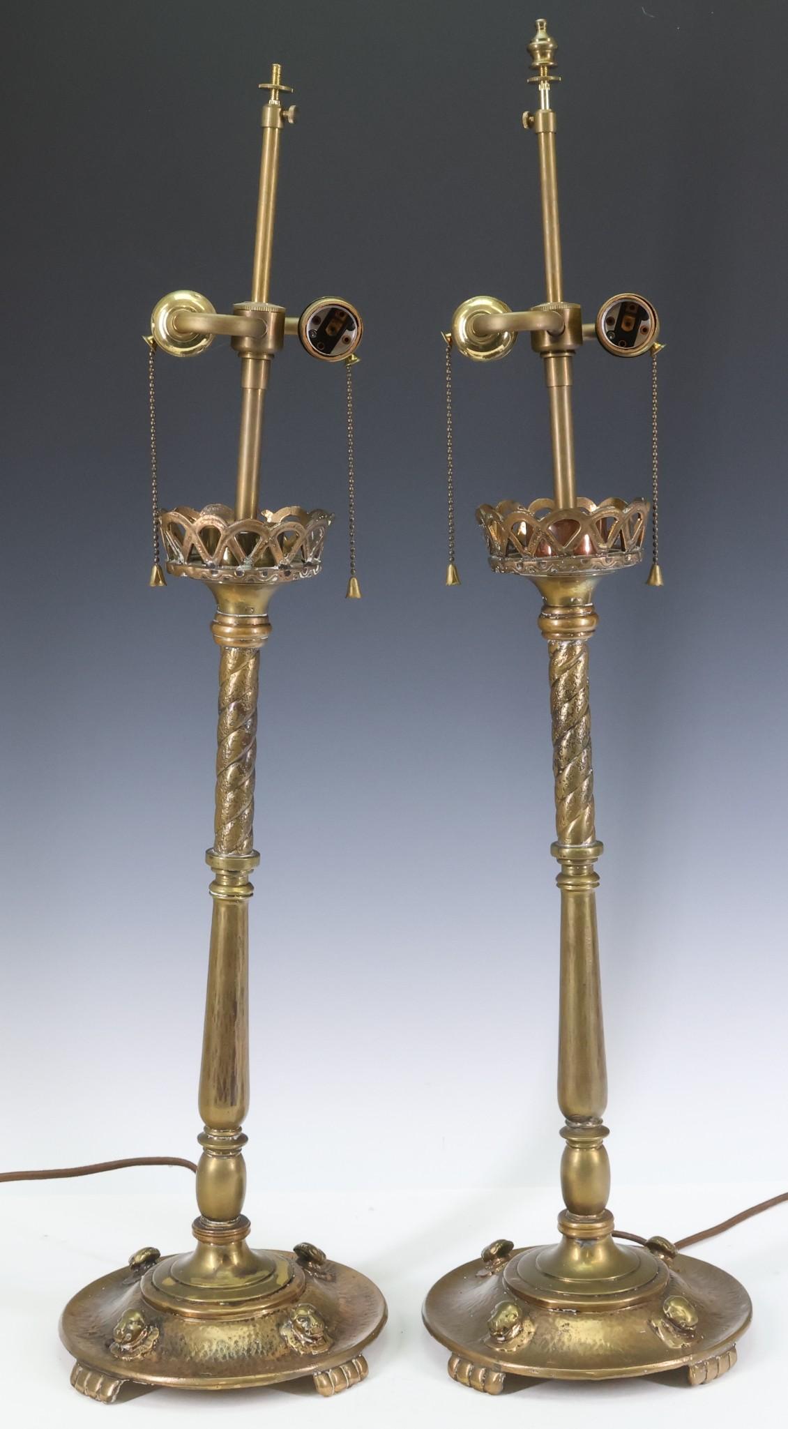 Oscar Bach Table Lamps: Gilt bronze and white metal, pair of 2-light table lamps, featuring lion mask decorated bases with paw feet, and minaret form twist stems with galleries, Oscar B. Bach, NY tags to the bases. One lamp