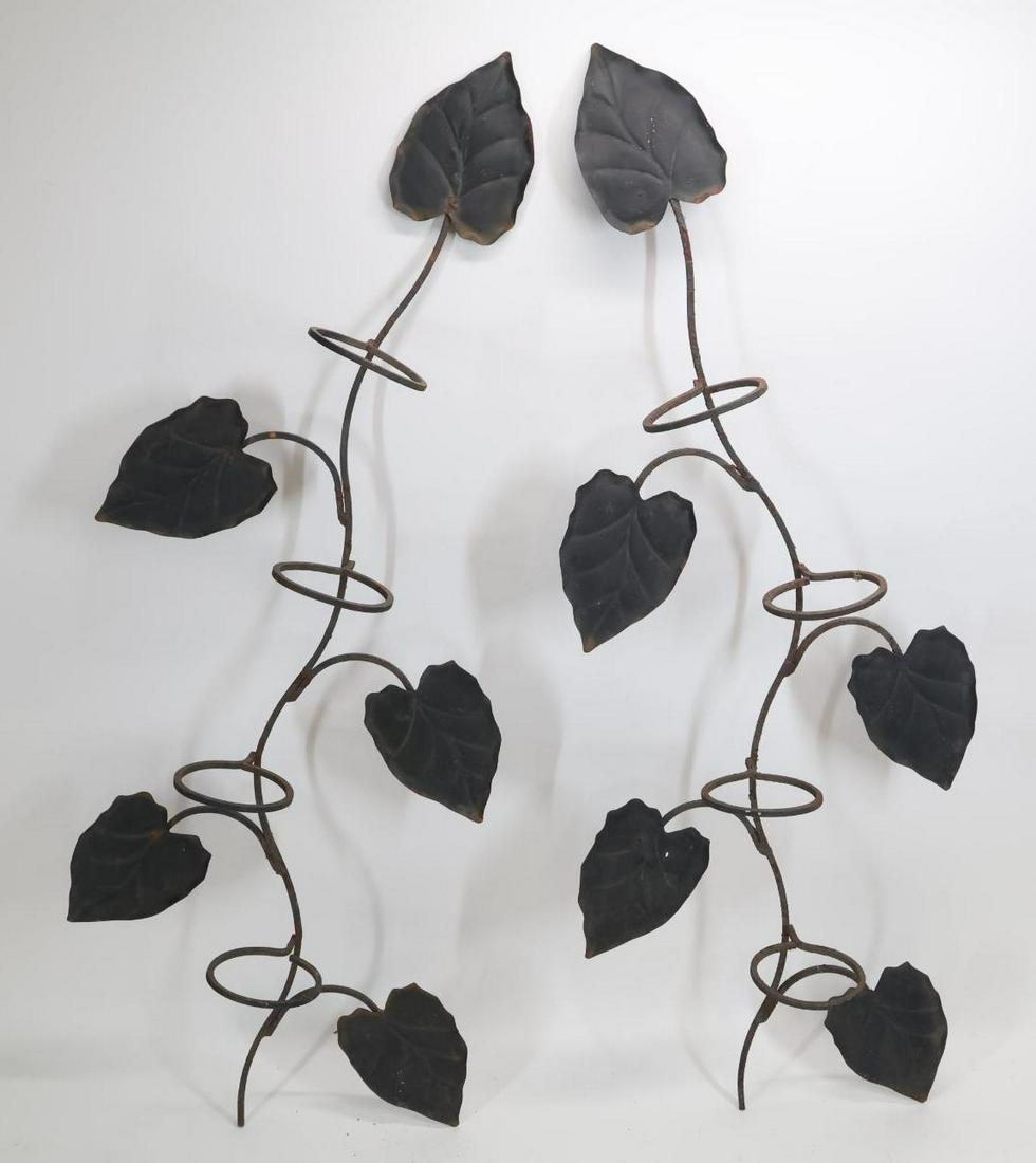 Manner of John Salterini Hanging Planters: Wrought iron pair of hanging planters in the form of espaliered trees, unmarked. Some rusting; a leaf on one planter has some holes. 45”h x 17"w x 6.5"d**Please Note: This item is NOT eligible f