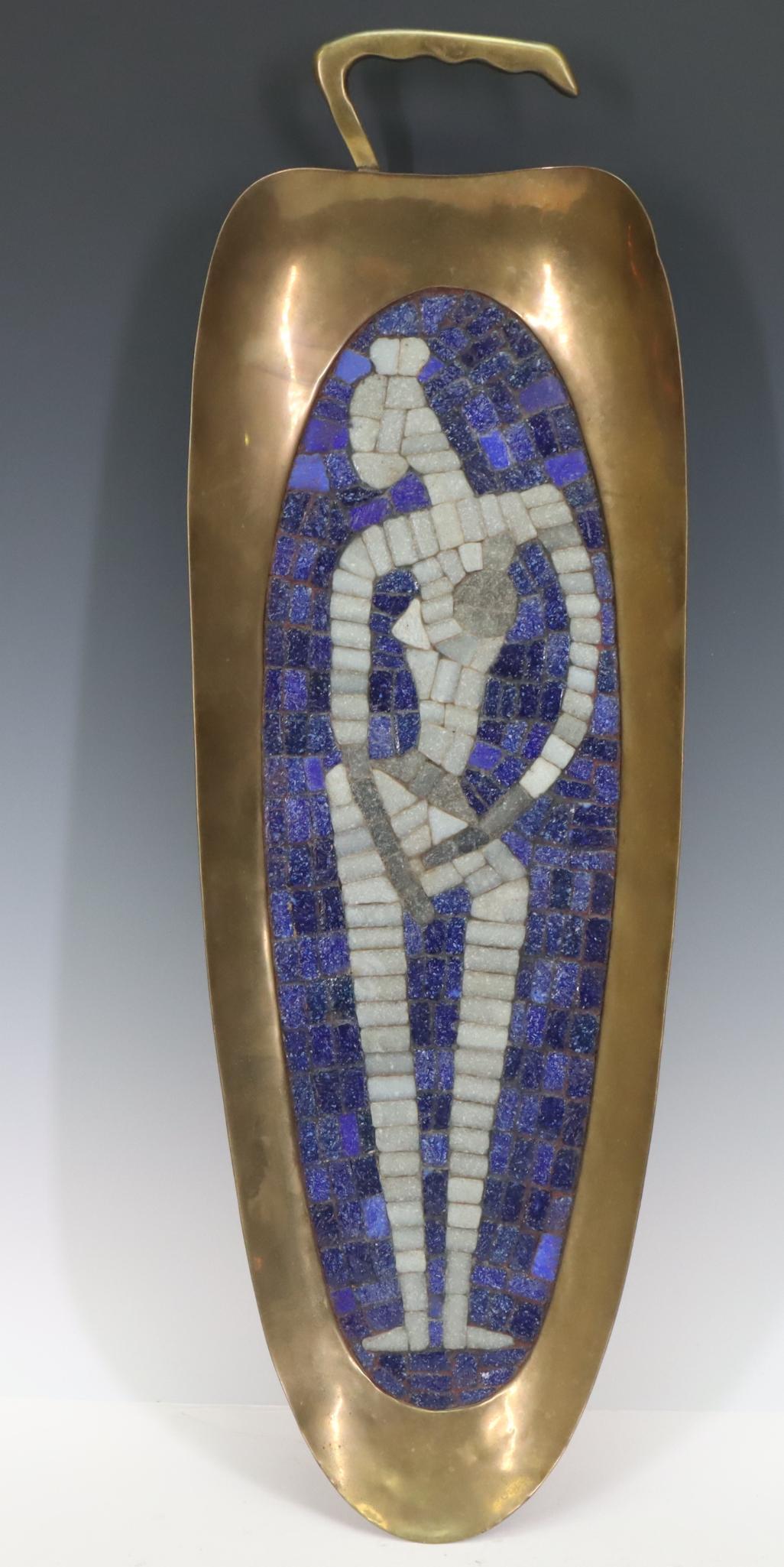 Salvador Teran (1920-1974): Hand wrought brass serving tray in the form of a chili pepper decorated with a mosaic tile female figure. 22” x 7"