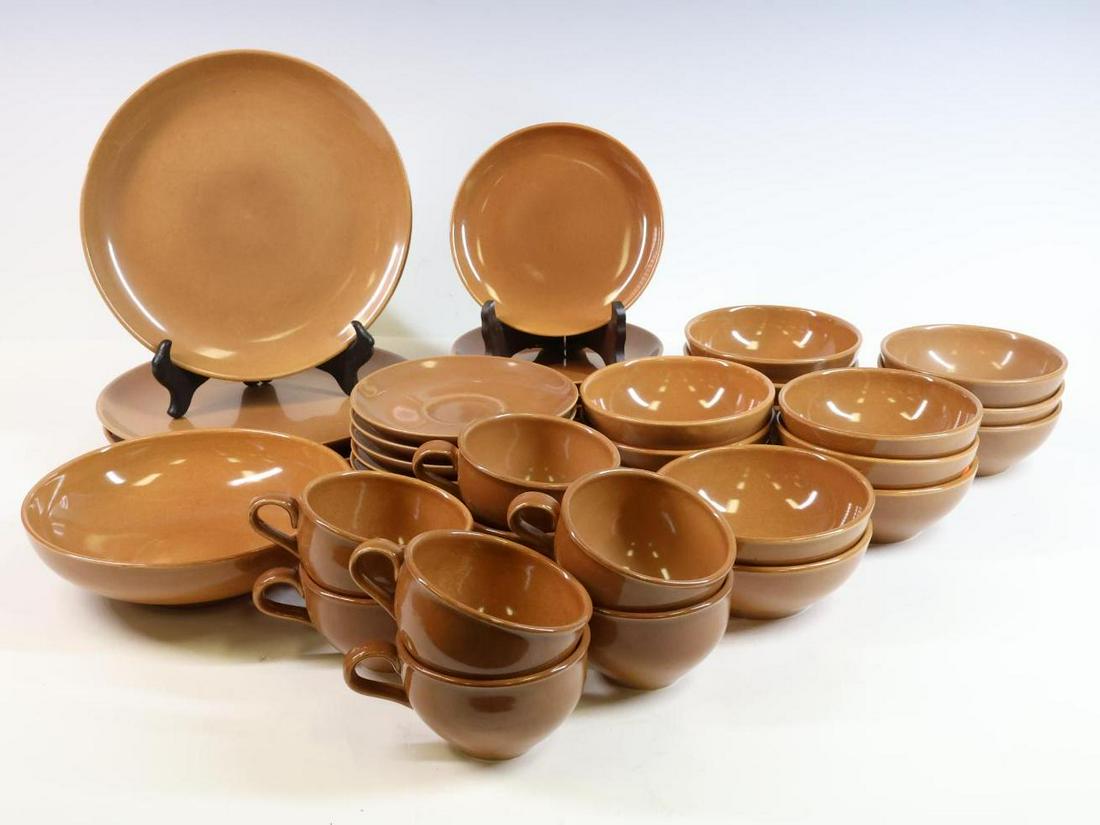 Russel Wright Dinnerware: Ceramic brown glazed, 40 pieces including plates, bowls, shallow serving bowls, coffee cups and saucers. Largest plate 10" round **Please Note: This item is NOT eligible for in-house shipping. Please