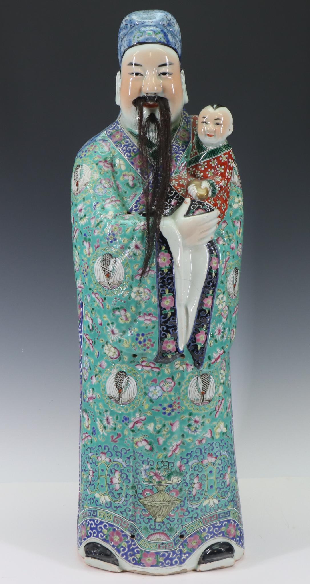 Chinese Famille Rose Fu Xing Figure: Tall statue of Fu Xing in polychrome enamel robes, holding a child, with applied facial hair, 20th century. 25"h x 7.5"w x 5.5"d **Please Note: This item is NOT eligible for in-house shipping. Please