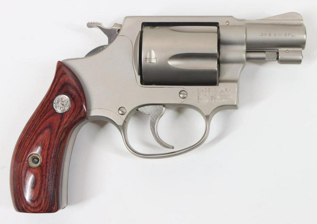 Smith & Wesson Model 36 Double Action Revolver: 38 Special, 1 7/8" bbl, SN 211055. Matte nickel finish with light cylinder drag line, good bore, narrow serrated hammer and narrow ribbed trigger, laminated wood grips show light handling. Very good c