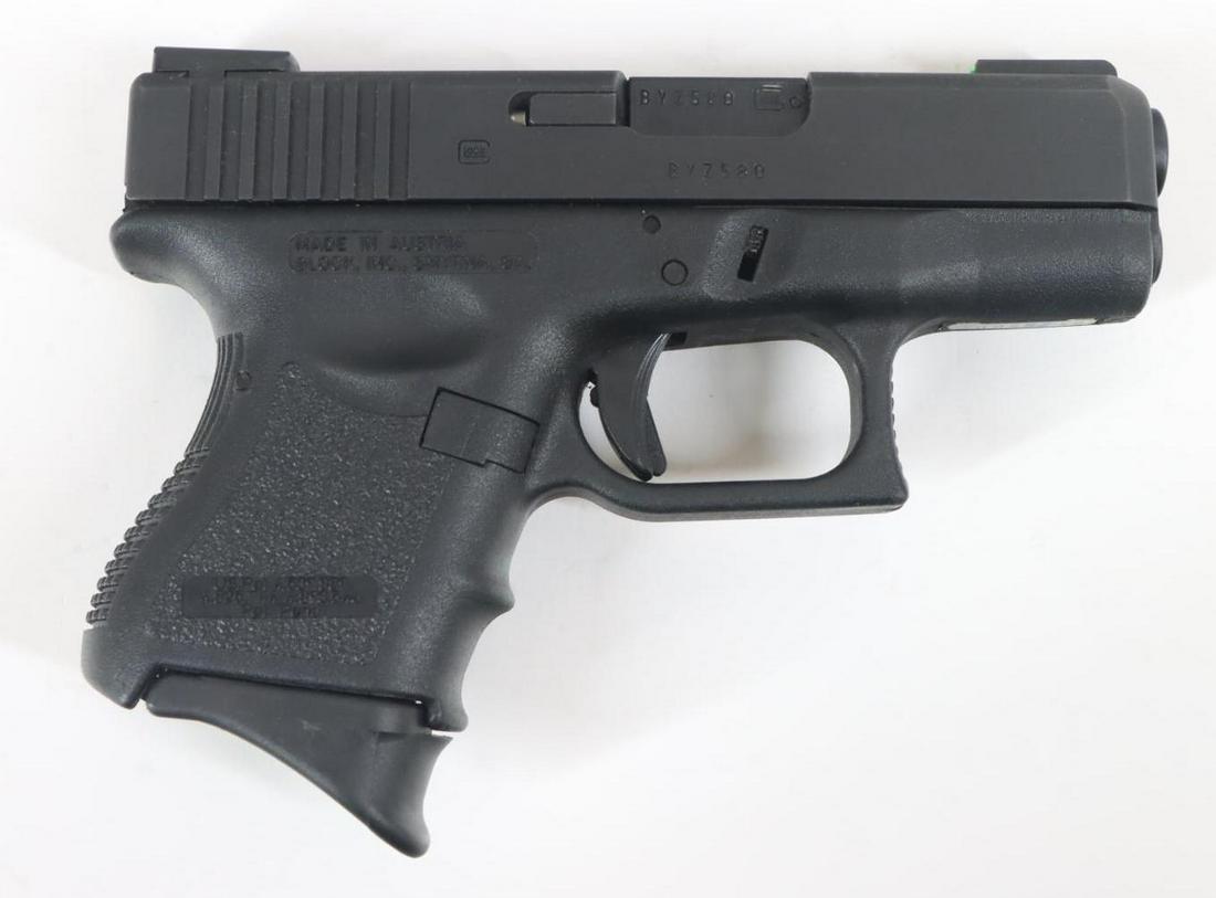 Glock Model 27 Semi Automatic Pistol: 40 S&W, 3 1/4" bbl, SN BYZ580. 98% matte black finish shows average handling, good bore, black polymer frame/grips shows light handling, 2-9 rnd magazines and Safariland tactical holster. Very good co
