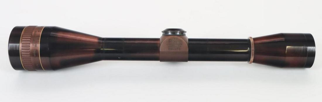 Leupold Rifle Scope: 10X with tapered cross hairs with ranging and clear optics, body shows plum color with ring marks. Removed from prior lot. Good Condition