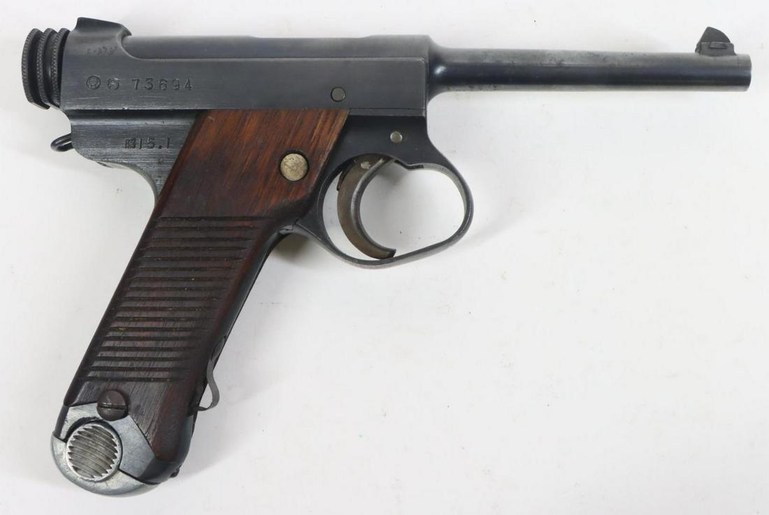Japanese Nagoya Type 14 Nambu Semi Automatic Pistol: 8x22mm Nambu, 4 5/8" bbl, SN 73694. 80% blue finish shows thinning on most edges and a few scattered light freckles, very good bore, oversized trigger guard, fixed lanyard ring, ribbed wood grips show