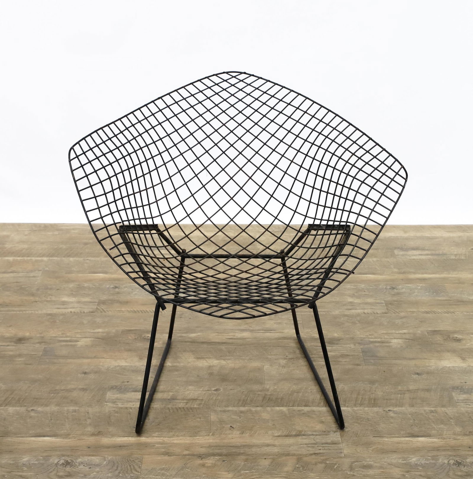 Harry Bertoia for Knoll Diamond Chair: Steel wire with black powder coat finish, unmarked. No seat pad; the wire rods are detached from the frame in a few spots; some oxidation and other surface wear; a screw has been replaced. 30"h x 32"w