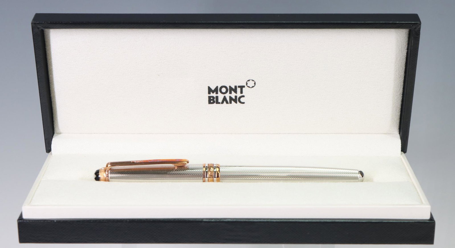 Montblanc Fountain Pen, 18k Nib: Montblanc Fountain Pen, sterling silver, star cap, black and metal textured, 18k Nib, original box included.